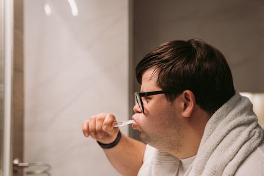 man brushing teeth in the mirror